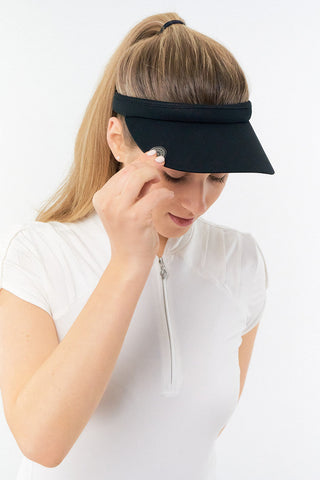 Black Clip ladies golf visor constructed with quick-drying fabrics. The visor comes in a one size fits all design which clips around your head to hold it securely in place. It also features a concealed magnet  in peak with a hand enamelled lace effect golf ball marker attached, making it a lovely golf accessory, golf gift! The headband features a soft lined absorbent towel.
