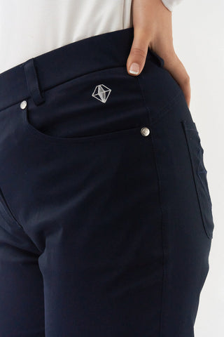Navy Ladies golf trousers made from flexible lightweight 4 way stretch material.  Featuring a zip and button fastening with five belt loops, a regular fit with anti-crease and anti-static properties. These women's golf trousers have two open pockets to the front and back. Size 8 to 20.