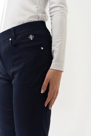 Navy Ladies golf trousers made from flexible lightweight 4 way stretch material.  Featuring a zip and button fastening with five belt loops, a regular fit with anti-crease and anti-static properties. These women's golf trousers have two open pockets to the front and back. Size 8 to 20.