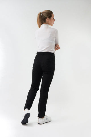 Black ladies golf trousers made from flexible lightweight 4 way stretch material.  Featuring a zip and button fastening with five belt loops, a regular fit with anti-crease and anti-static properties. These women's golf trousers have two open pockets to the front and back. Size 8 to 20.