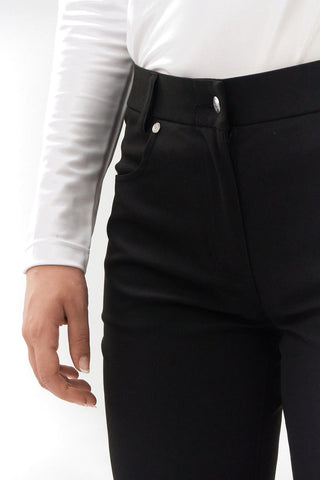 Black ladies golf trousers made from flexible lightweight 4 way stretch material.  Featuring a zip and button fastening with five belt loops, a regular fit with anti-crease and anti-static properties. These women's golf trousers have two open pockets to the front and back. Size 8 to 20.