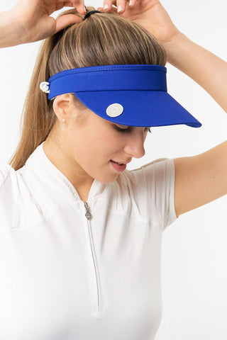 Royal Blue  ladies golf visor constructed with quick-drying fabrics. The visor comes in a one size fits all design with an elasticated cord at the rear to hold it securely in place. It also features a concealed magnet  in peak with a hand enamelled lace golf ball marker attached, making it a lovely golf accessory, golf gift! The headband features a soft lined absorbent towel.
