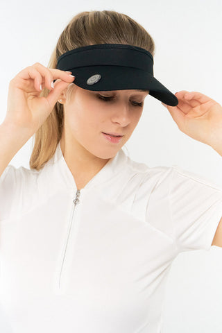 Black ladies golf visor constructed with quick-drying fabrics. The visor comes in a one size fits all design with an elasticated cord at the rear to hold it securely in place. It also features a concealed magnet  in peak with a hand enamelled lace golf ball marker attached, making it a lovely golf accessory, golf gift! The headband features a soft lined absorbent towel.