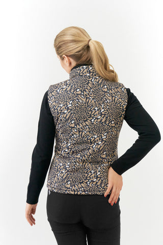 The Pure Golf Eve reversible ladies gilet for golf is insulated, winter-weight, patterned and reversible. It has been Insulated for warmth without being bulky. It has a unique animal print in wild truffle,  on one side and black on the other for versatility of wear. It has pockets on both sides and two-way zippers. The flattering quilting style and fit enhances your silhouette. The colors in this  this piece are Cappuccino,  Champagne and black.