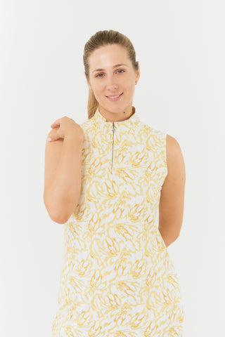 The Pure Golf close up model shot of the Miley Sleeveless dress from the back features our sunkissed print and honey hues. Made in 4-way stretch material for maximum flexibility and unrestricted movement with detachable shorts for versatility and coverage. The mock neck collar offers a sleek, modern look and is a flattering fit on all body types. Designed to be anti-crease, anti-static, and quick drying. It provides UPF 50+, 95% Polyester and 5% Spandex.