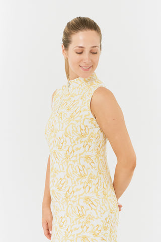 The Pure Golf side model shot of the Miley Sleeveless dress from the back features our sunkissed print and honey hues. Made in 4-way stretch material for maximum flexibility and unrestricted movement with detachable shorts for versatility and coverage. The mock neck collar offers a sleek, modern look and is a flattering fit on all body types. Designed to be anti-crease, anti-static, and quick drying. It provides UPF 50+, 95% Polyester and 5% Spandex.