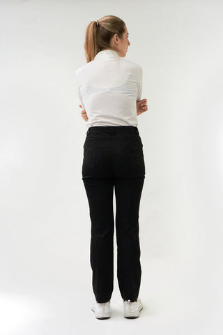 Black ladies golf trousers made from flexible lightweight 4 way stretch material.  Featuring a zip and button fastening with five belt loops, a regular fit with anti-crease and anti-static properties. These women's golf trousers have two open pockets to the front and back. Size 8 to 20. 