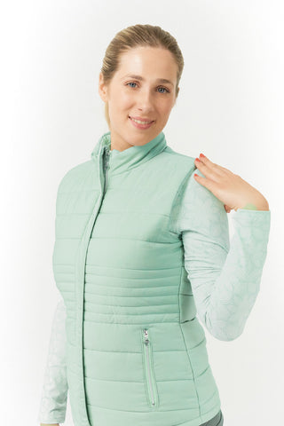 Frosted Sage Pure Golf Eve reversible ladies gilet for golf is insulated, winter-weight, patterned and reversible. It has been Insulated for warmth without being bulky. It has a unique frosted field, floral print  on one side and plain frosted sage on the other for versatility of wear. It has pockets on both sides and two-way zippers. The flattering quilting style and fit enhances your silhouette. 