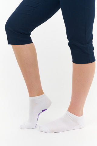 White ladies trainer golf sock, 3 pack with 2 stripped purple pairs and one plain white pair with the word "golf" on the sole, also with a cushioned sole and compression fit. The lower cut around the ankle makes them less visible when worn. Made from a soft, stretchy cotton blend fabric allows breathability. They are suited to UK sizes between 4 and 7. 85% Cotton, 13% Polyester, 2% Elastane.